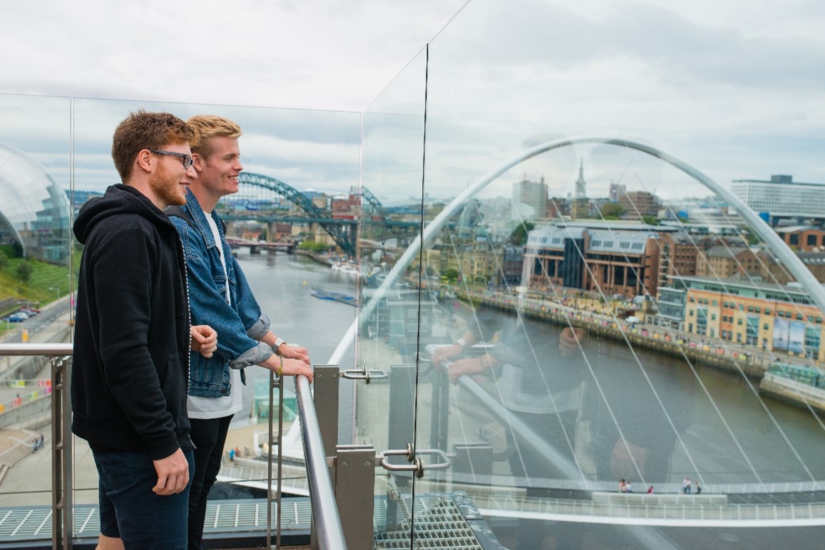Image of people looking over the Gateshead Millennium Bridge in Newcastle