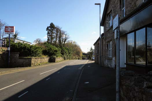 Pavement, road and buildings at the beginning of the Arnside Knott circular walking route.