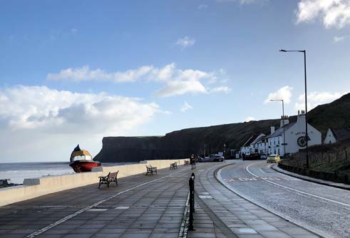 A winding road by the sea on the Saltburn coastal walking route in North Yorkshire.