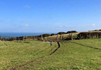 Mud path through a field toward Warsett Hill in Saltburn, North Yorkshire.