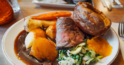 Plate of roast beef wth poatoes, vegetables and gravy