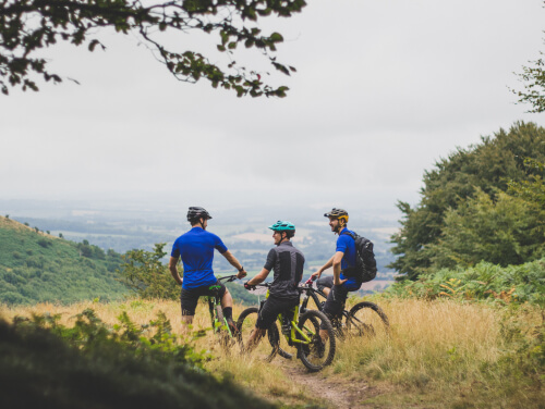 3 people on bikes in the countryside