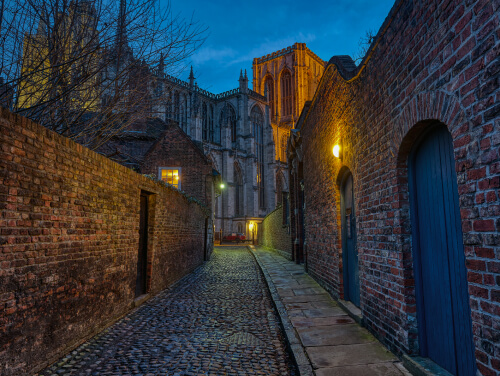 A dimly lit alleyway to a cathedral in York