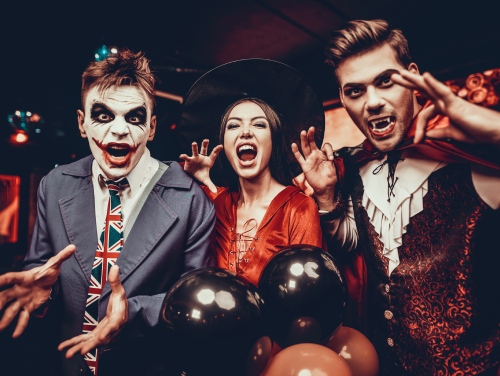 Three adults in costumes at a Halloween party