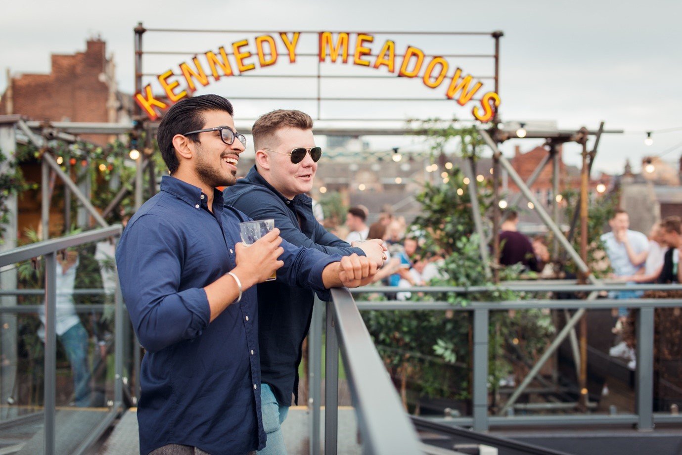 Image of two men enjoying a drink at the Kennedy Meadows bar in Leeds