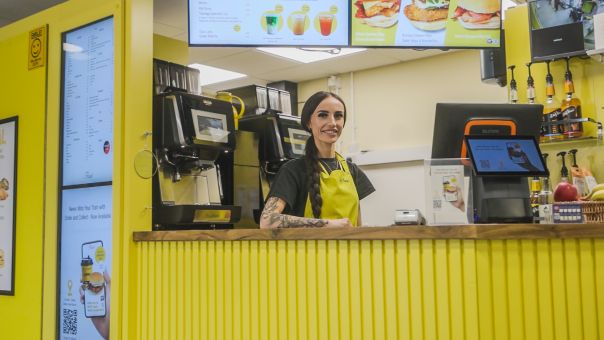 Lady smiling at front of Le Feast in Bolton