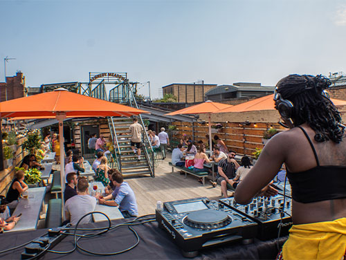 DJ entertaining the crowd at Headrow House rooftop bar in Leeds