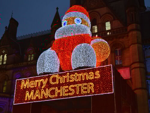 An image of a light up Santa statue with the words 'Merry Christmas Manchester' underneath.