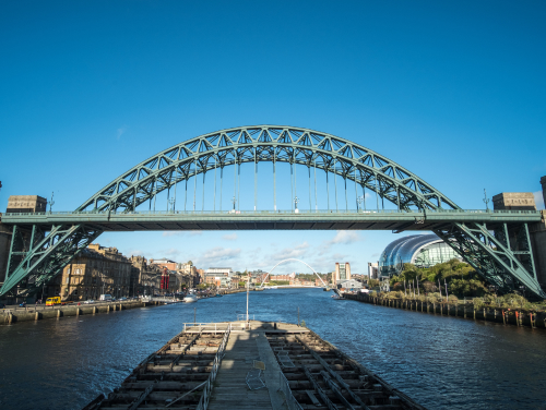 Tyne Bridge spanning the River Tyne, with Newcastle and Gateshead landmarks along the waterfront.