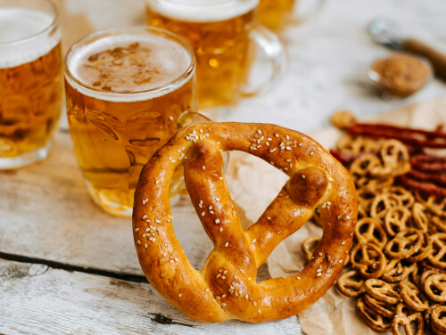 Beers and pretzels on a table.