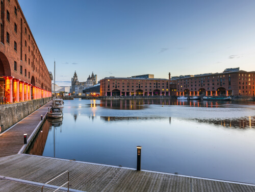 The Royal Albert Docks waterfront, with the shops visible across the water.