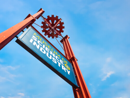 the sign for the science and industry museum in manchester with the sky as the background.