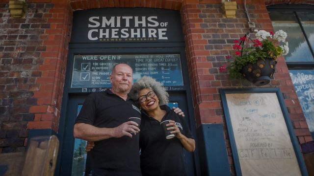 Owners of Smiths of Cherise smiling outside cafe