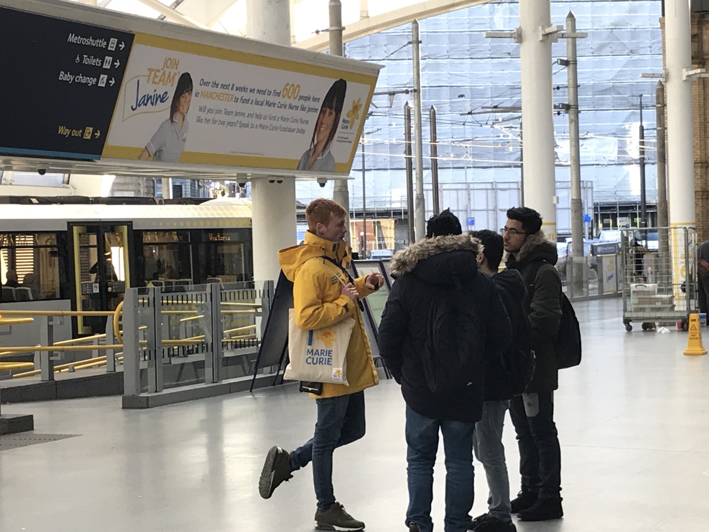 Experiential advertising with banners, staff and giveaways at railway stations