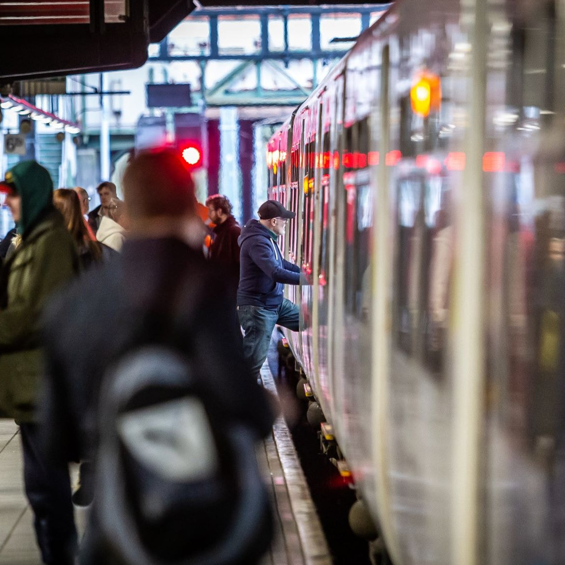 Image shows customers boarding a train cropped