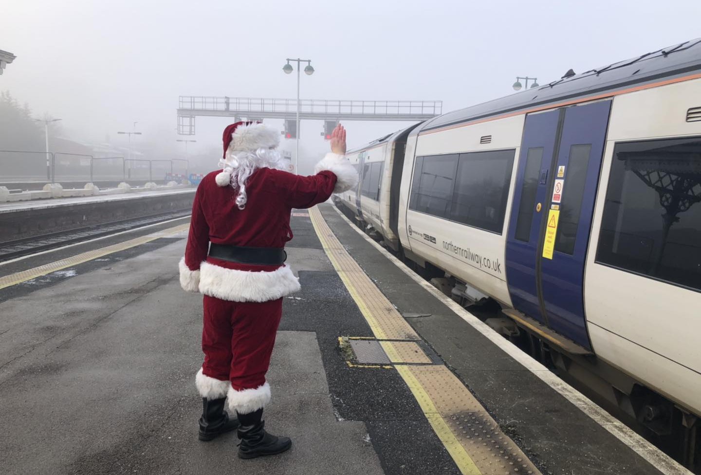 this-image-shows-father-christmas-waving-to-the-santa-express-train
