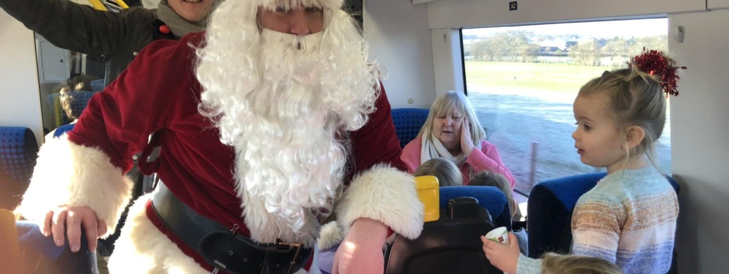 this-image-shows-father-christmas-spreading-festive-cheer-on-a-northern-train