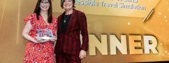 Maxine Myers holding the award with host Zoe Lyons maxine-myers-holding-the-award-with-host-zoe-lyons