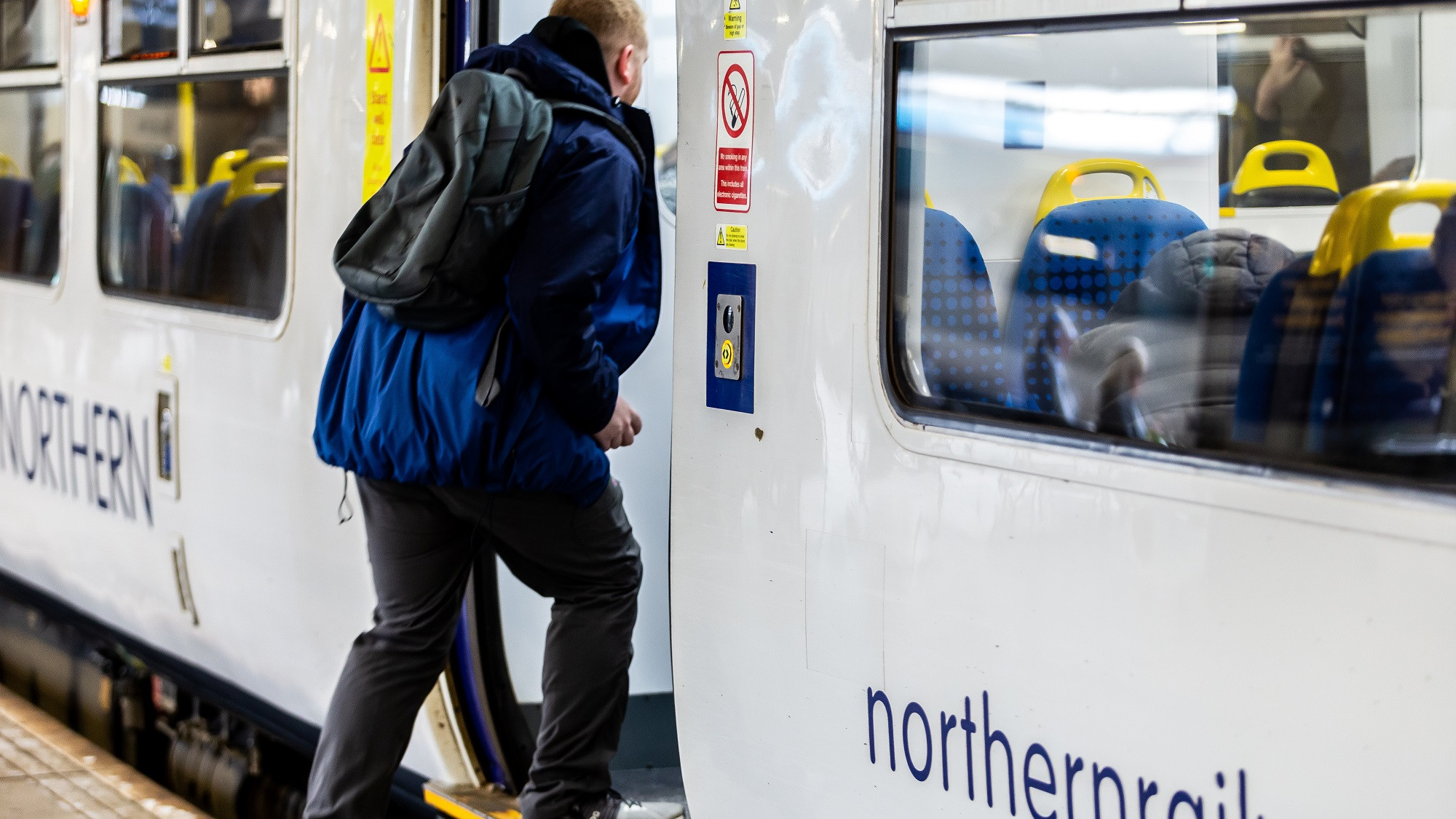 Image shows customer boarding a train