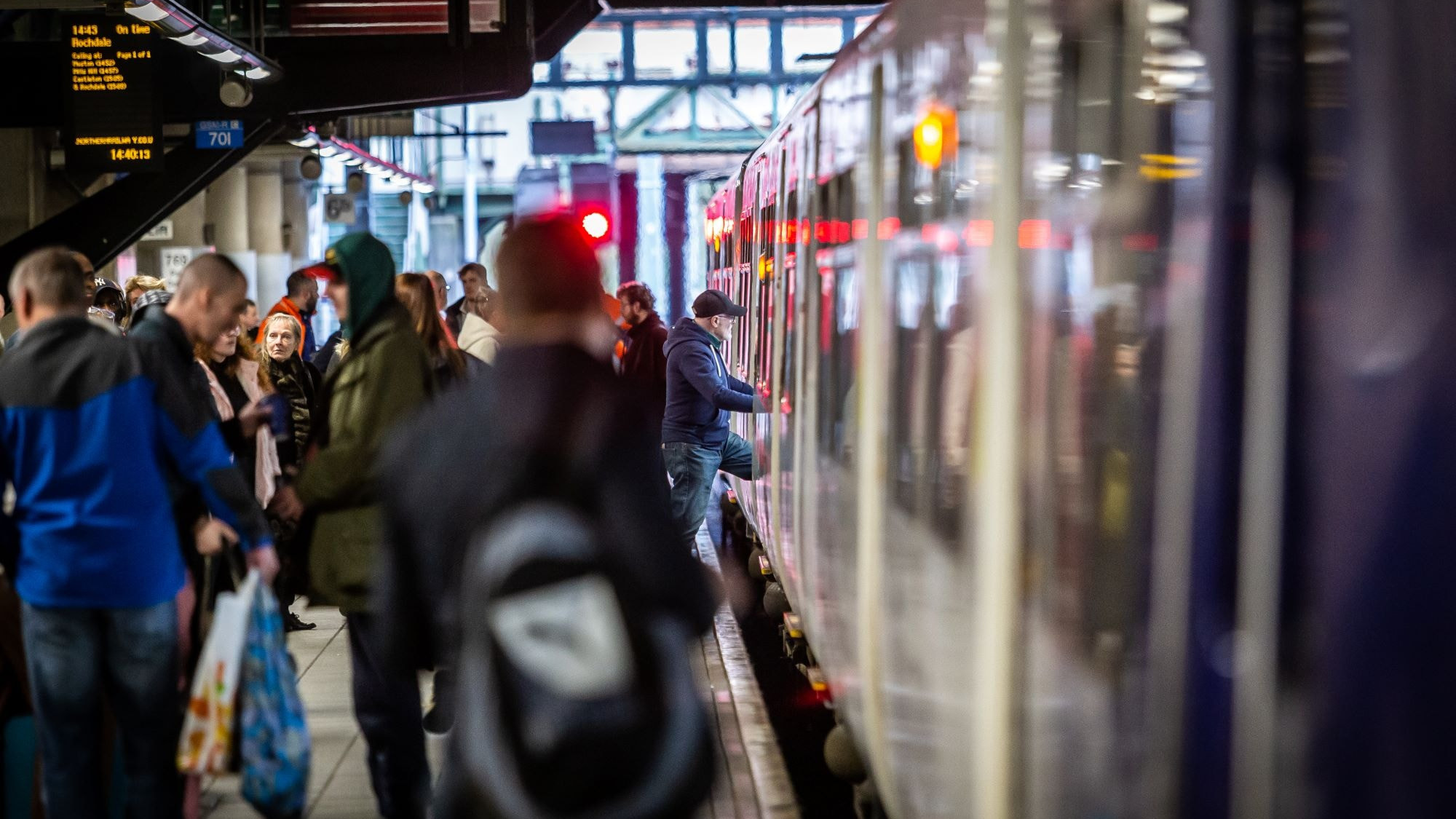 Image shows customers boarding a train cropped