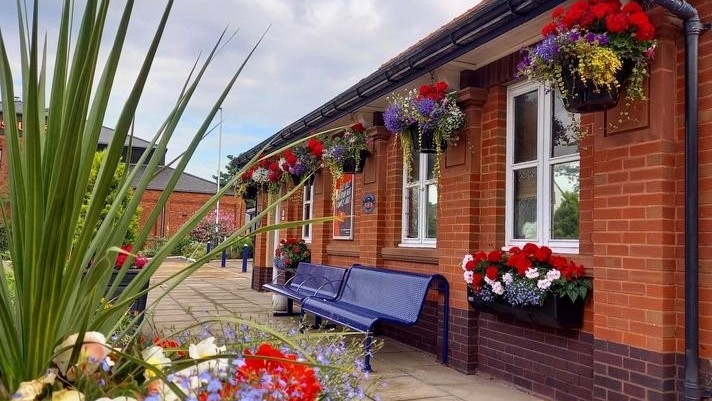 Image shows floral displays at St Annes on the Sea station (2022)