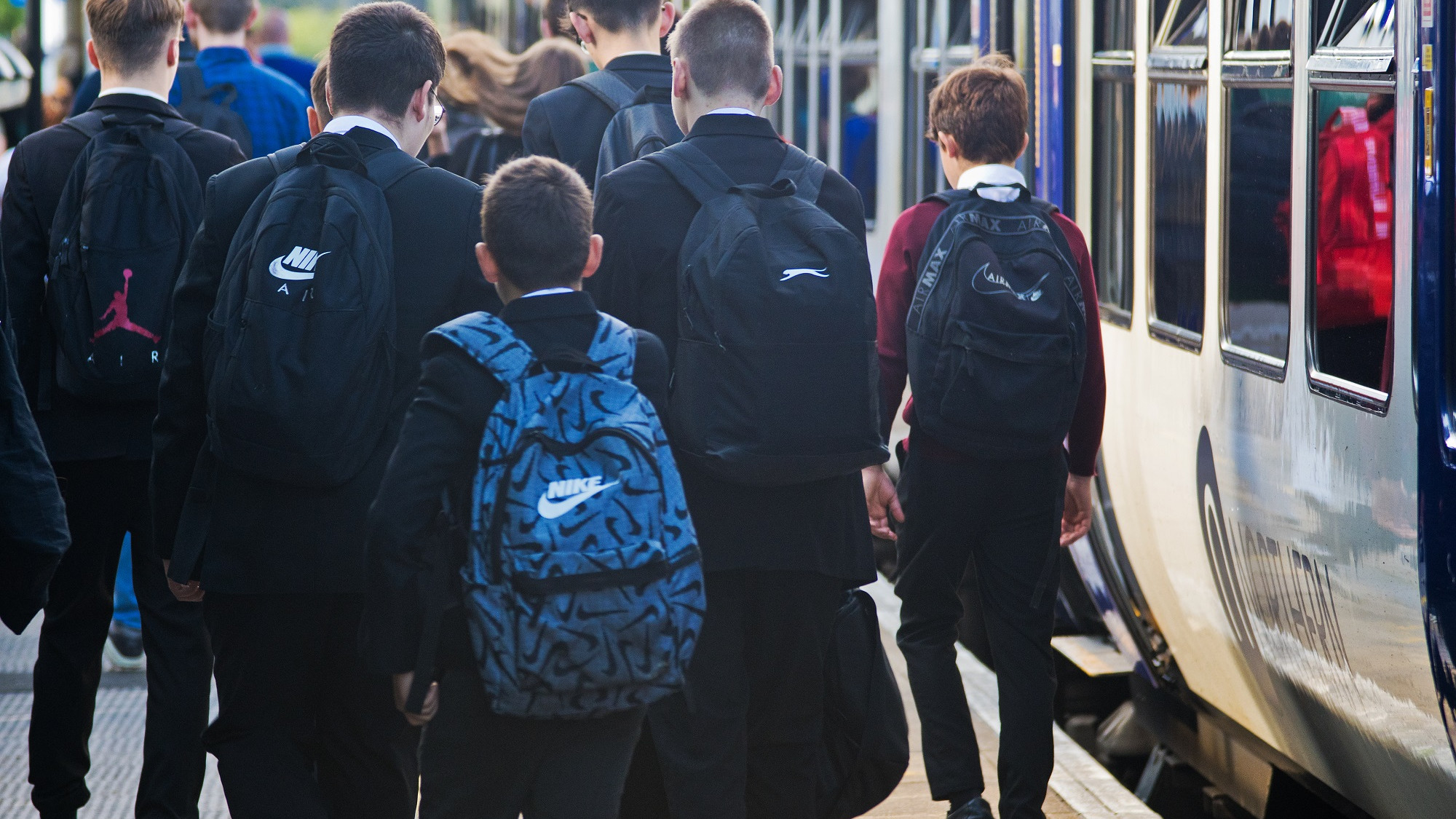 Image shows schoolchildren disembarking a Northern train