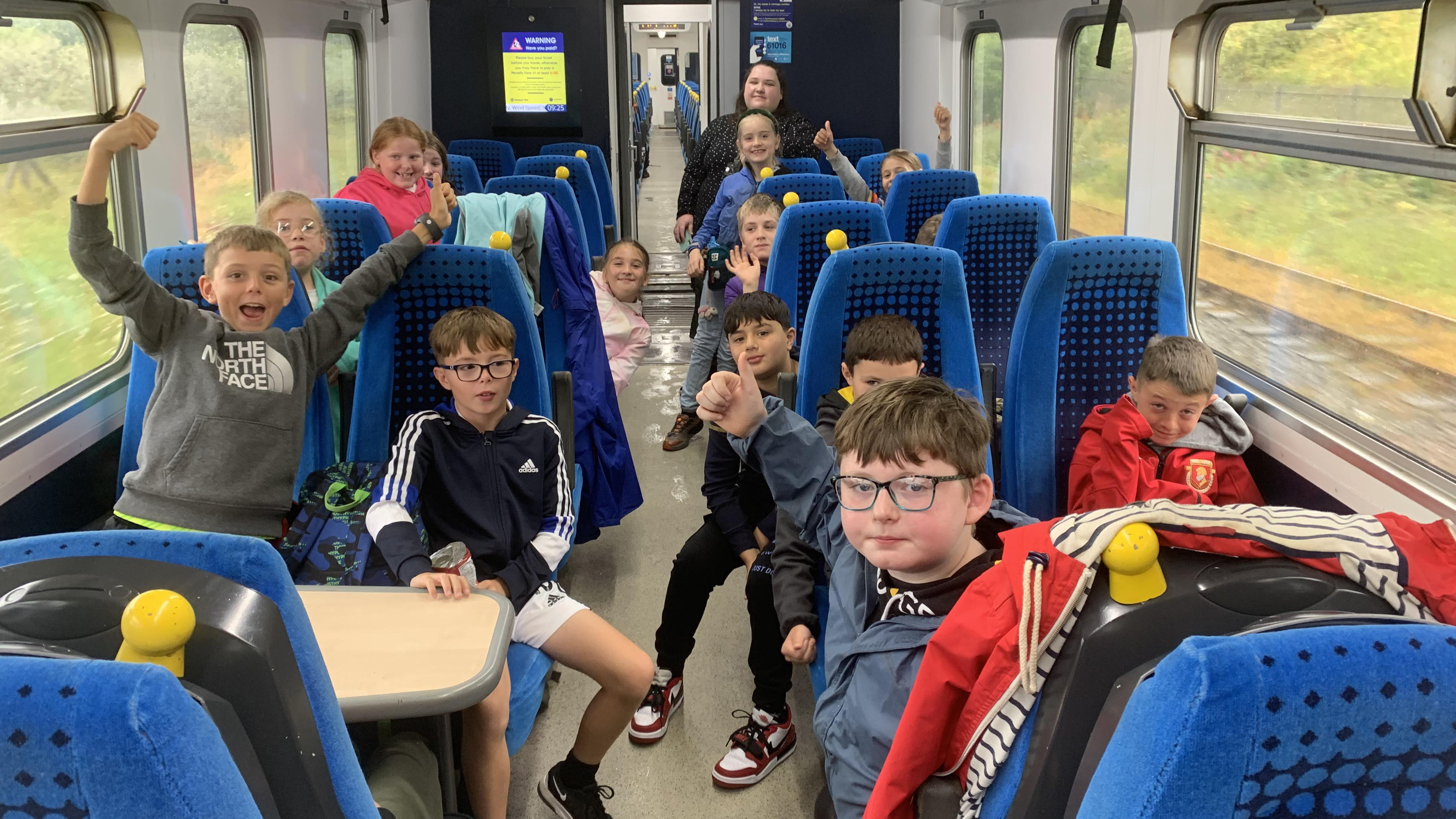 This image shows children from Shackles off enjoying their trip on a Northern train