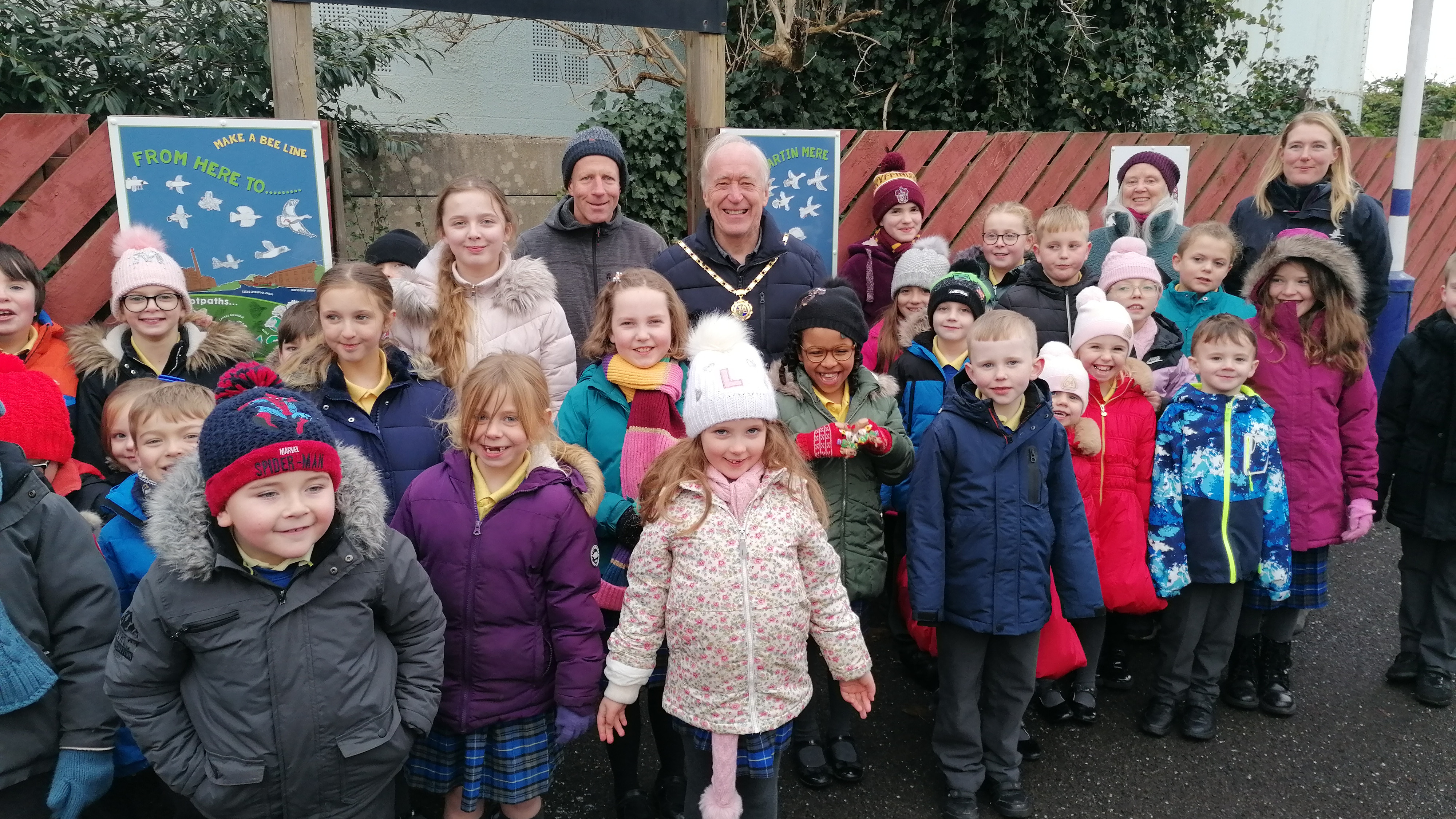 This image shows the school pupils showing off their artwork