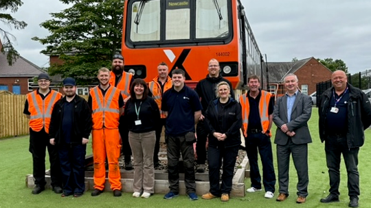 This images shows the Heaton team in front of the class 144 classroom
