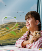 Young child looking out of Northern Train Window at the countryside