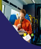 Teacher grading papers on a train