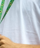 A boy in a white t-shirt holding a sunflower lanyard.